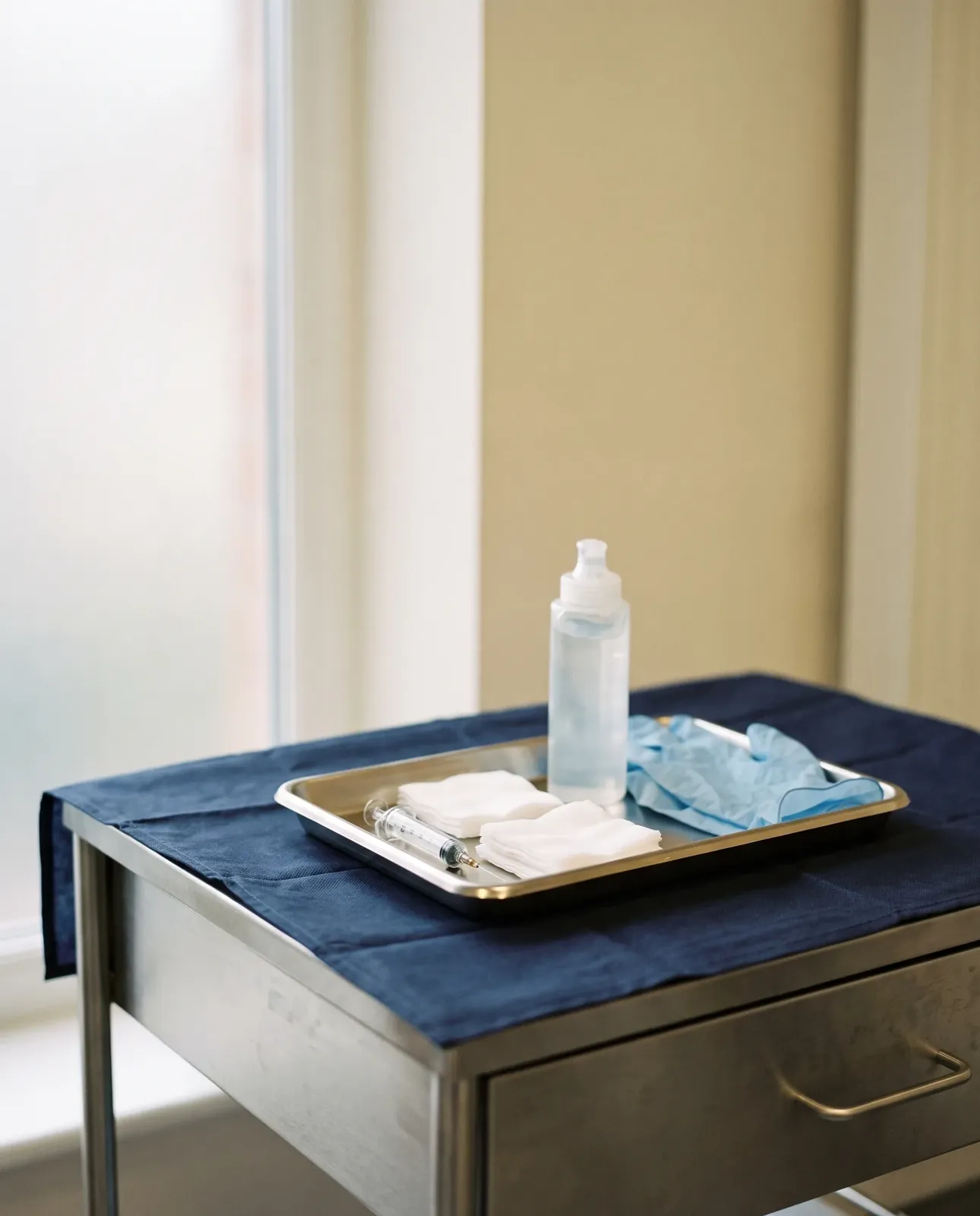 A sterile dressing tray prepared on a clinic trolley